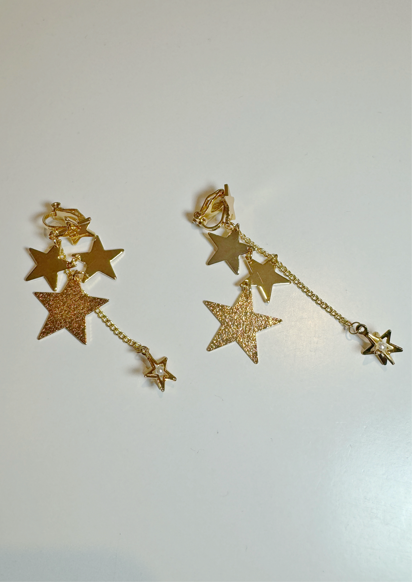 Golden Stars Chain Tassel Clip On Earrings. gold-tone clip-on earrings for women.