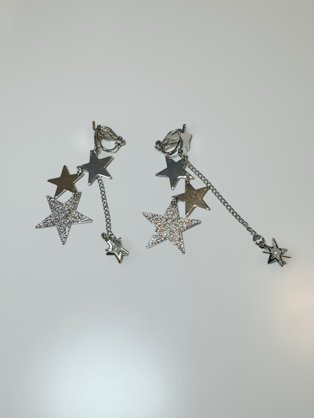 Silver Stars Chain Tassel Clip On Earrings. silver-tone clip-on earrings for women.
