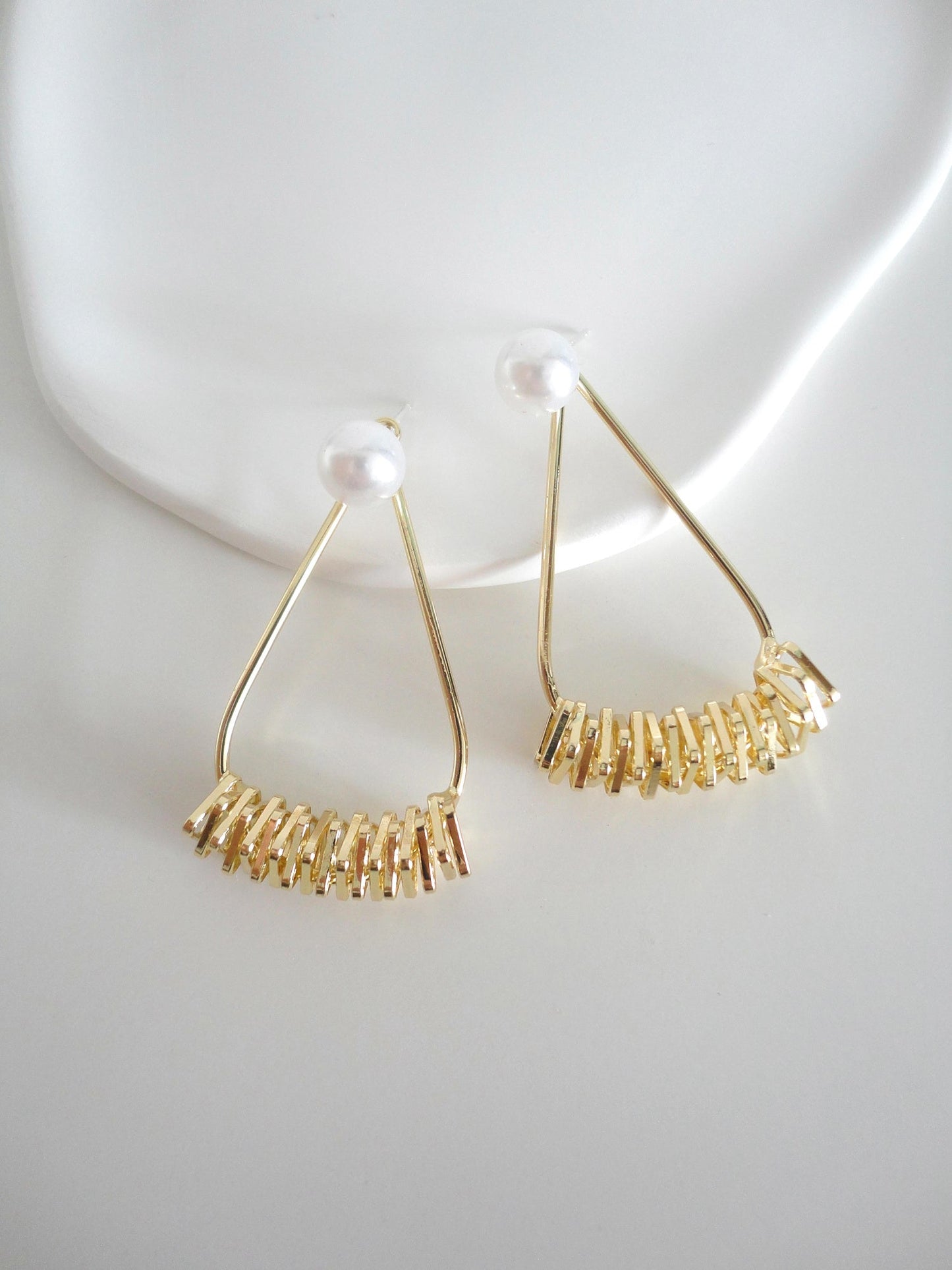 Pearl and Golden Textured Triangle Drop Earrings. pearl, gold-tone clip-on earrings for women.