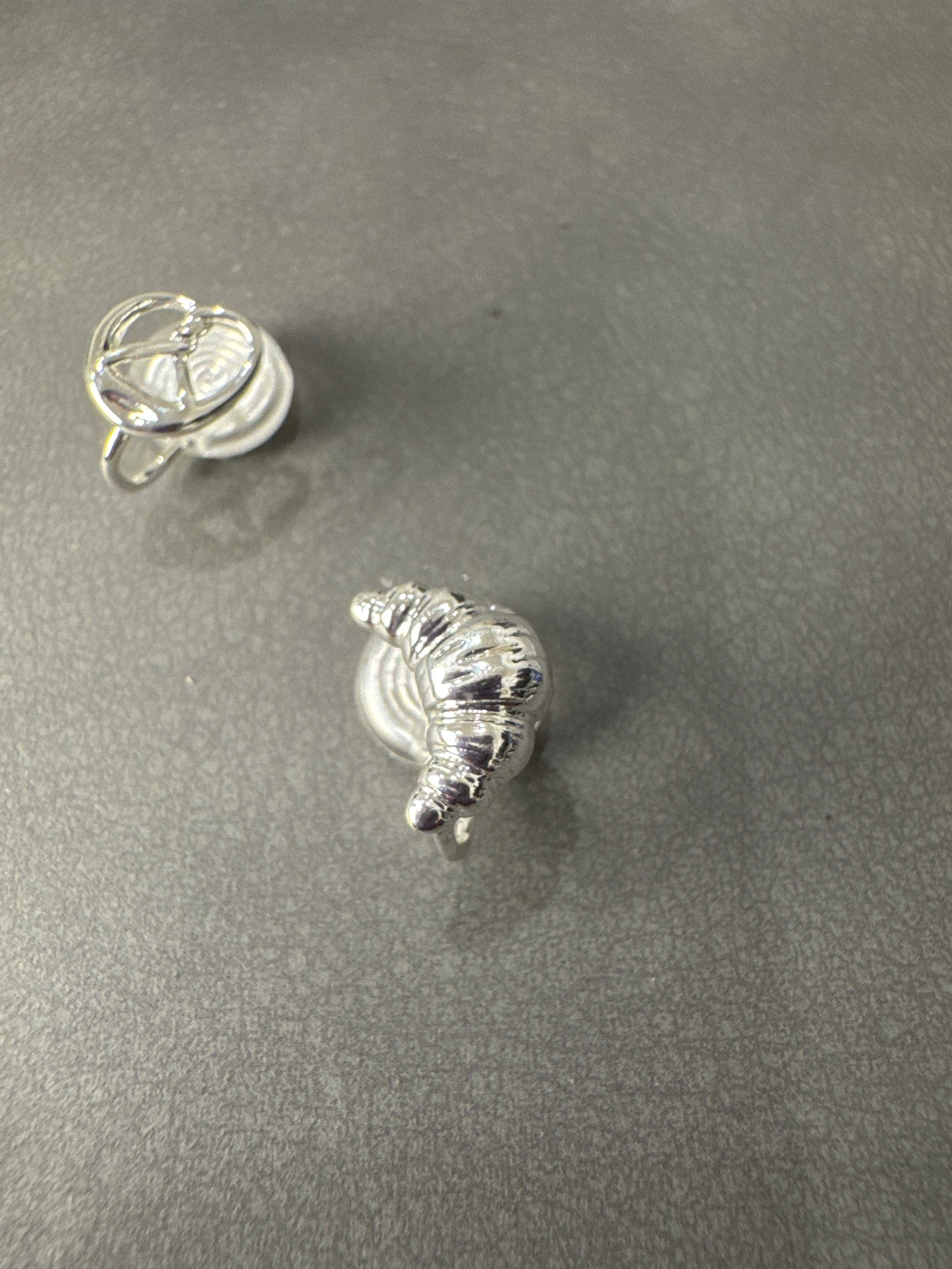 Silver Metal Small Croissant and Pretzel Mismatch Clip On Earrings
